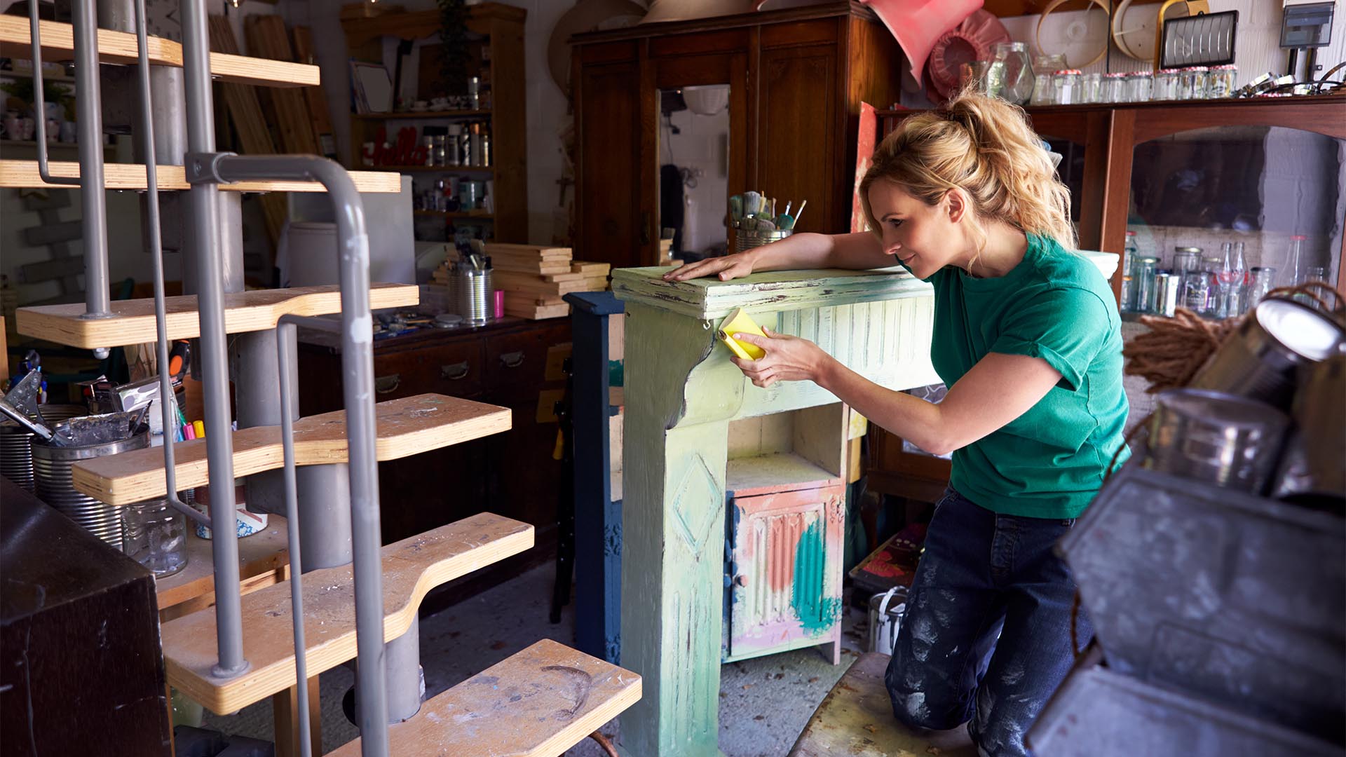 Woman In Workshop Upcycling And Working On Fire Surround